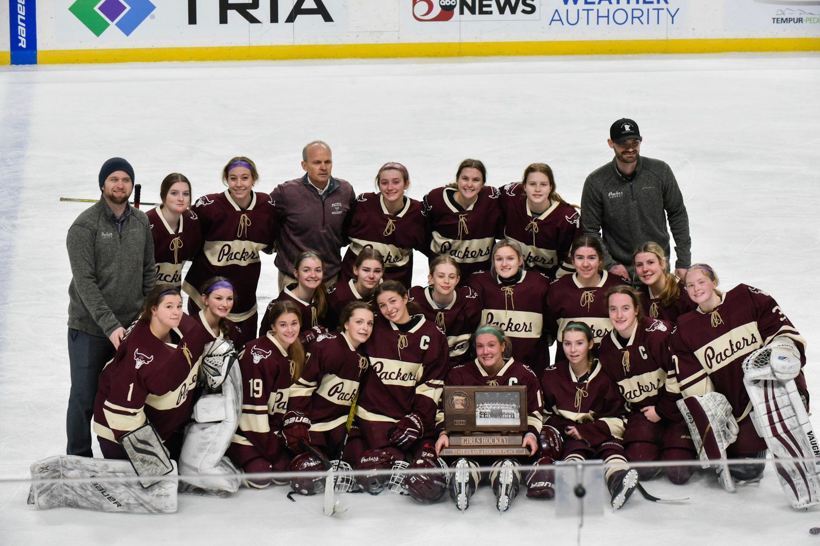 Packers team photo on the ice with a trophy